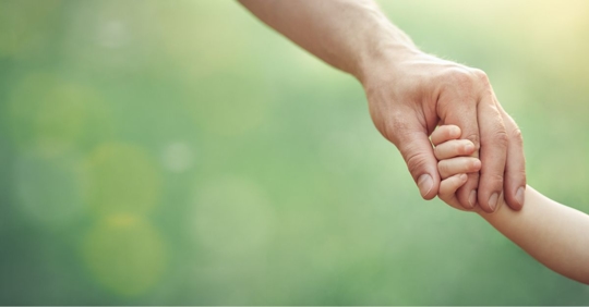 Dad holding hand with child